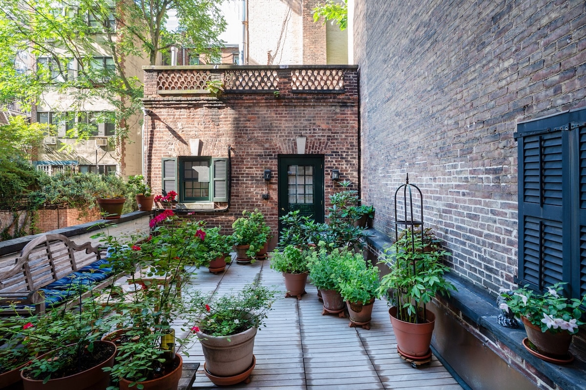 Terrace with many planters. Wood decking.