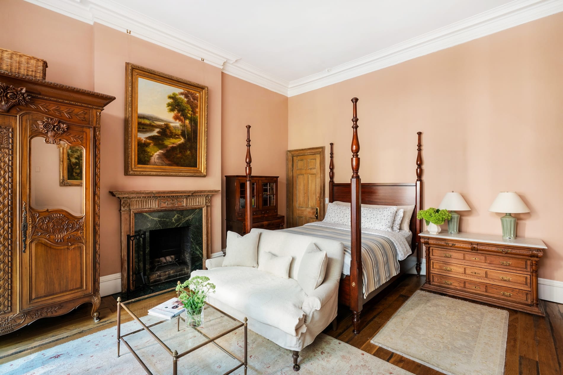 Spacious Room, high ceilings, Pink Walls, Brown 4 poster bed with cream colored bedding, Cream colored sofa at foot of bed