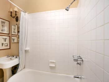 bathroom with white tile and pedestal sink