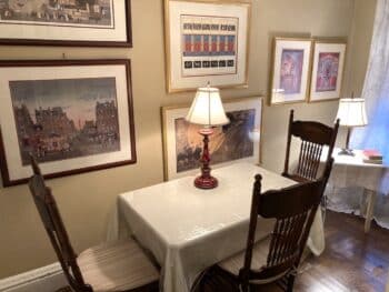 Small room with table and chairs and prints on the wall